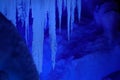 CLOSE UP: Crystal clear rods of ice hang from the ceiling of a frozen cavern.