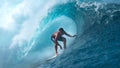 CLOSE UP: Crystal clear water splashes over surfer riding an epic barrel wave. Royalty Free Stock Photo