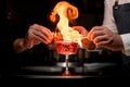 close-up of crystal goblet with cocktail that bartenders impressively sets to fire