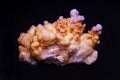 Close up of crystalline spherical aragonite crystals isolated on black background.