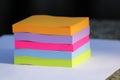 Close up of a cube of piled sticky notes of several pastel and bright colors Royalty Free Stock Photo