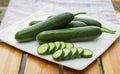 Close up cucumber slice in white dish on wood table. Royalty Free Stock Photo