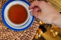 close up of cup of tea with blue stripes at home ,teatime and relax