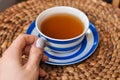 close up of cup of tea with blue stripes at home ,teatime and relax