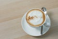 Close up a cup of cappuccino coffee on wooden table