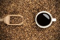 Close up cup of coffee and beans with wooden shovel