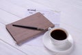 Close-up cup of coffee with ink pen and book. Royalty Free Stock Photo