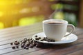 Close up a cup of hot coffee with roasted coffee beans Royalty Free Stock Photo