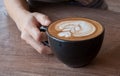 Close up of Cup of hot latte art coffee on wooden table Royalty Free Stock Photo