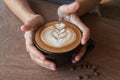 Close up of Cup of hot latte art coffee on wooden table Royalty Free Stock Photo