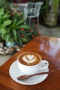 Close-up cup of latte coffee on wooden (Selective focus)