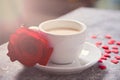 Close up of cup of tea with red rose and small candy hearts on the table Royalty Free Stock Photo