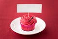 Close up of cupcake with red buttercream frosting