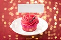 Close up of cupcake with red buttercream frosting