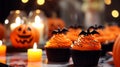 Close-Up Of Cupcakes And Pumpkin On Table During Halloween Celebration.