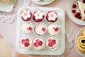 Close up, cupcakes on tray decorated with pink flowers Royalty Free Stock Photo