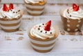 Close-up cupcakes with whipped eggs cream decorated fresh strawberry and chocolate balls on old white wooden table background Royalty Free Stock Photo