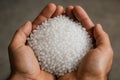 Close-up of cupped hands holding white recycled plastic pellets Royalty Free Stock Photo