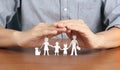 Close up of cupped hands showing protecting  paper chain family Royalty Free Stock Photo