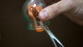 Close up for cupping therapist hand heating up a cupping glass with a flame, isolated on black background. Acupuncturist Royalty Free Stock Photo