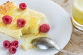 Close-up of curd casserole with raspberries, honey and spoon on white plate and glass with smoothie on wooden cut. Royalty Free Stock Photo