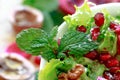 Close up of curly endive salad with pomegranate, nuts... Royalty Free Stock Photo