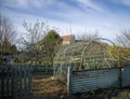 Curved greenhouse structure on a sunny day.