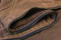 A close up of curvy golden zip teeth track on the brown denim fabric Royalty Free Stock Photo