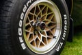 Close up on custom alloy wheel of black Pontiac Firebird