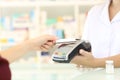 Customer paying with credit card reader in a pharmacy Royalty Free Stock Photo