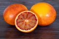 Cut blood oranges isolated on a wooden background Royalty Free Stock Photo