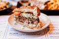 Close up cut half of Cheeseburger with grilled beef, feta cheese and sliced tomato served in white plate Royalty Free Stock Photo