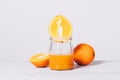 Close-up of a cut orange and fresh juice in a glass jar Royalty Free Stock Photo