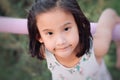Close up of Cute Asian child girl is smiling happily in the park. Royalty Free Stock Photo