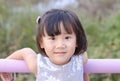 Close up of Cute Asian child girl is smiling happily in the park. Royalty Free Stock Photo