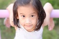 Close up of Cute Asian child girl is smiling happily in the park. Royalty Free Stock Photo