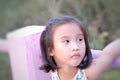 Close up of Cute Asian child girl is smiling happily in the park. Royalty Free Stock Photo