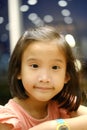 Close up of Cute Asian child girl is smiling happily in the restaurant. Royalty Free Stock Photo