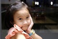 Close up of Cute Asian child girl is smiling happily in the restaurant. Royalty Free Stock Photo