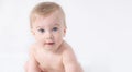 Close-up cute little adorable funny amazed caucasian blond topless baby girl or boy on white,light grey background Royalty Free Stock Photo