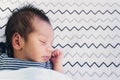 Close up of cute little newborn asian baby boy sleeping on bed at children bedroom with copy space. family, healthy, life and Royalty Free Stock Photo