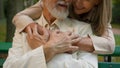 Close up cute mature elderly married Caucasian couple woman embracing hugging man retired happy family holding hands Royalty Free Stock Photo