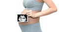 Close up of a cute pregnant belly woman with ultrasound baby film. Isolated on white background with copy space Royalty Free Stock Photo