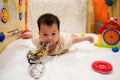 Close-up Cute toddler Girl hold climbing rope , and try flying on white bed in children Royalty Free Stock Photo