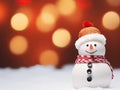 Close-up of a cute toy snowman in a red hat and scarf on a snowy background on a blurred bokeh background in winter Royalty Free Stock Photo