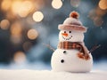 Close-up of a cute toy snowman in a red hat and scarf on a snowy background on a blurred bokeh background in winter Royalty Free Stock Photo