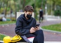 Close up cute young boy with black protective mask on face. Teenager wearing medical mask to protect from corona virus, illness, Royalty Free Stock Photo