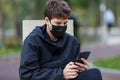 Close up cute young boy with black protective mask on face. Teenager wearing medical mask to protect from corona virus, illness, Royalty Free Stock Photo