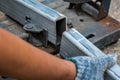 Close-up of cutted steel sections with compound mitre saw and ci Royalty Free Stock Photo