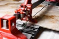 Close up of cutting ceramic tile with red manual tile cutter. Royalty Free Stock Photo